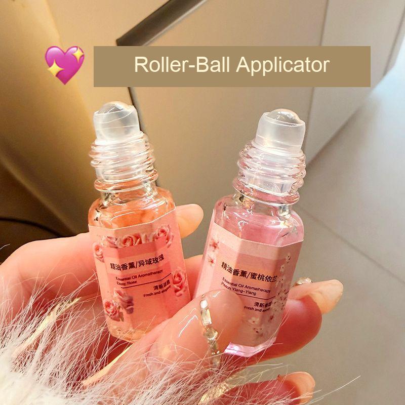 Close-up of the roller-ball applicators on two fragrance bottles