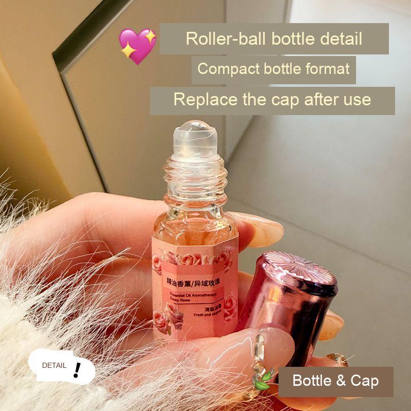 Uncapped rose-labelled fragrance bottle and matching cap, showing the roller-ball applicator