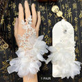 One pair of white floral bridal hand accessories with lace, fabric flowers and decorative stones