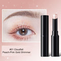 Shade 01 shimmer stick with peach pink gold shimmer shown on the eyelid
