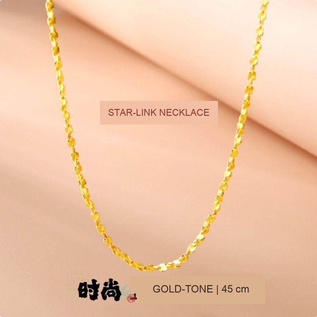 Fine gold-tone star-link necklace, 45 cm, shown worn at the neckline; no gold-purity claim is made