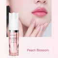 Pink lip oil with glossy lip appearance and Peach Blossom shade caption