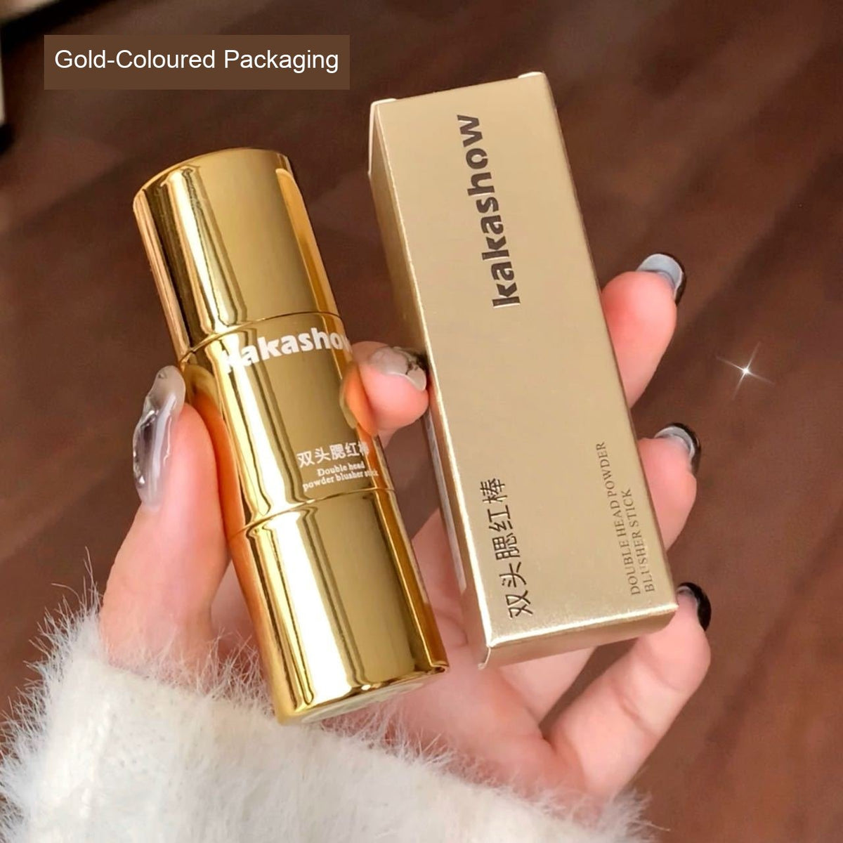 Kakashow double-ended powder blusher stick and matching box in gold-coloured packaging