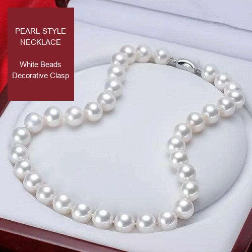 White pearl-style bead necklace with a decorative clasp, shown inside its presentation box